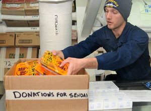 0331 US naval personnel pack donations for Japan.jpg